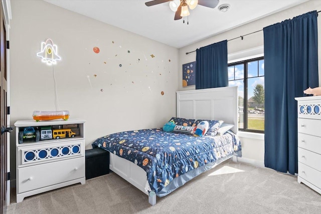 carpeted bedroom with visible vents and ceiling fan