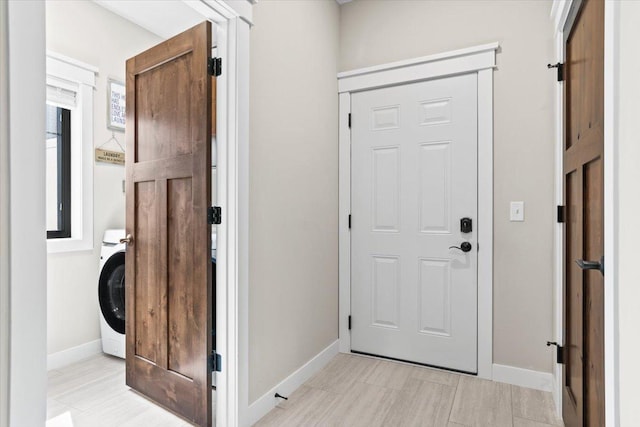 foyer featuring washer / clothes dryer and baseboards