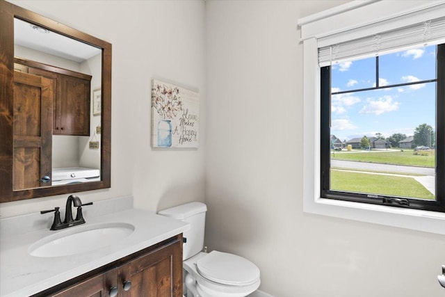 half bathroom featuring toilet and vanity