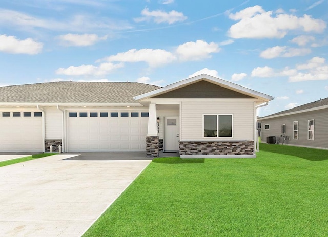 view of front of house with a front lawn, a garage, and central AC unit