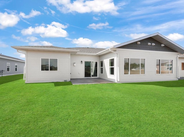 back of house featuring a lawn and a patio