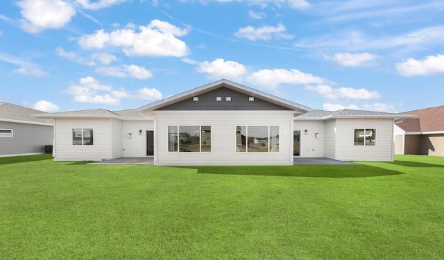 back of house featuring a yard and a patio