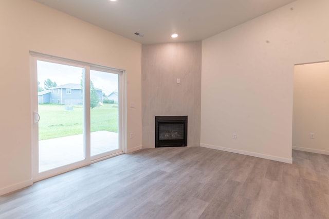 unfurnished living room with light hardwood / wood-style flooring and a fireplace