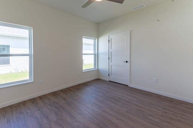 unfurnished room with dark wood-type flooring and ceiling fan