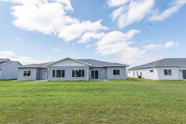 ranch-style house with a front yard and central AC unit