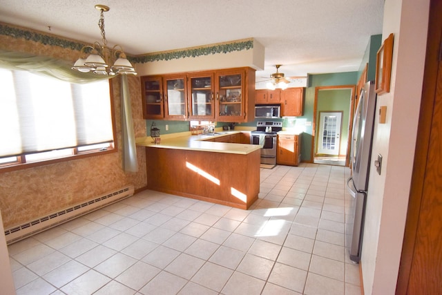 102 6th St SW, Red Lake Falls, MN 56750 - kitchen featuring appliances with stainless steel finishes, a baseboard heating unit, brown cabinets, a peninsula, and a chandelier