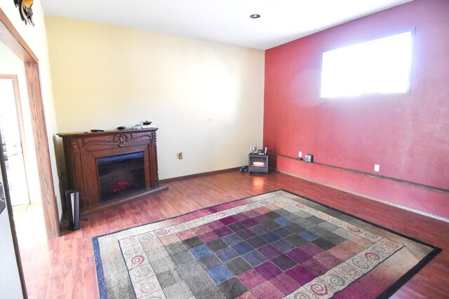 102 6th St SW, Red Lake Falls, MN 56750 - unfurnished living room with a glass covered fireplace, wood finished floors, and recessed lighting