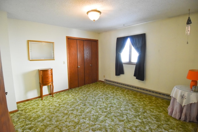 102 6th St SW, Red Lake Falls, MN 56750 - bedroom with a baseboard radiator, carpet flooring, a closet, a textured ceiling, and baseboards
