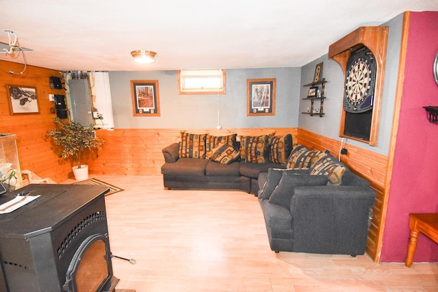 102 6th St SW, Red Lake Falls, MN 56750 - living room with wooden walls, wood finished floors, and a wood stove