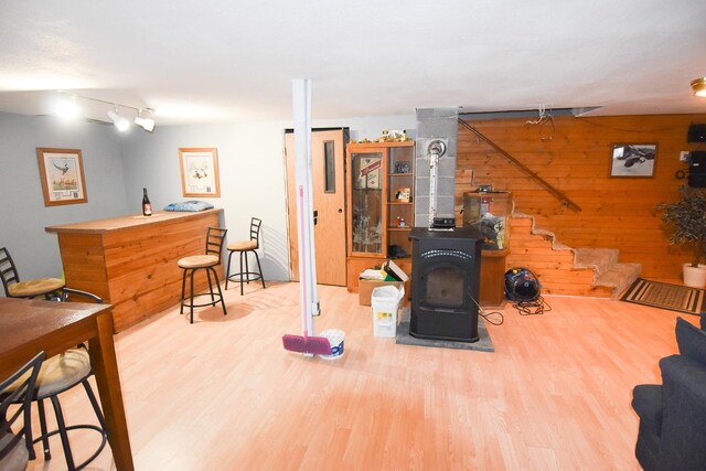 102 6th St SW, Red Lake Falls, MN 56750 - exercise area with a wood stove, wood finished floors, wood walls, and rail lighting