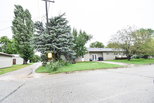 102 6th St SW, Red Lake Falls, MN 56750 - view of front facade featuring driveway, a front lawn, and french doors