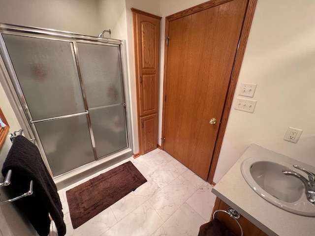 bathroom with vanity, marble finish floor, and a stall shower