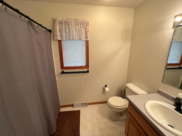 full bath with vanity, baseboards, visible vents, tile patterned floors, and toilet