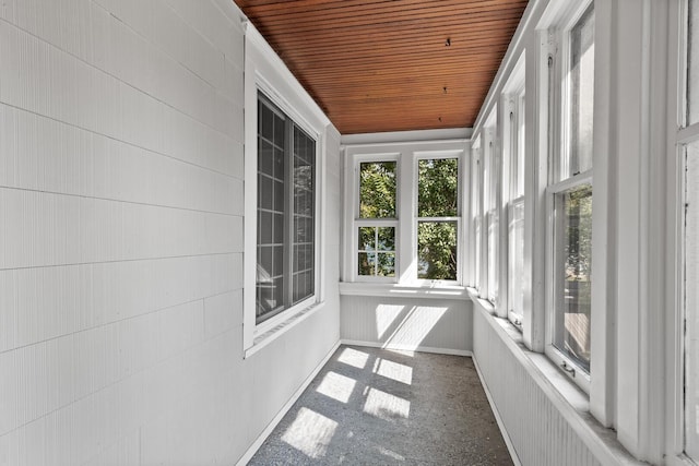 unfurnished sunroom featuring wood ceiling