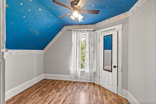 additional living space featuring ceiling fan, lofted ceiling, and hardwood / wood-style flooring