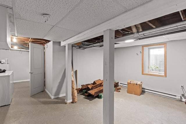 basement with a paneled ceiling and a baseboard radiator