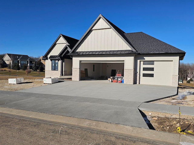 modern farmhouse featuring a standing seam roof, board and batten siding, concrete driveway, an attached garage, and metal roof