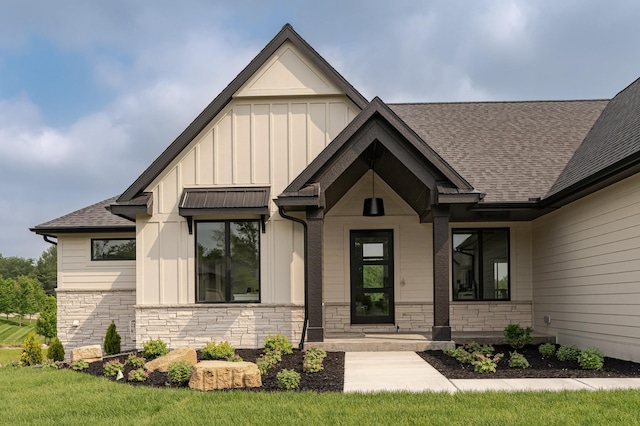 2665 Timber Oaks Rd SW, Rochester, MN 55902 - view of front of home with board and batten siding, stone siding, and roof with shingles