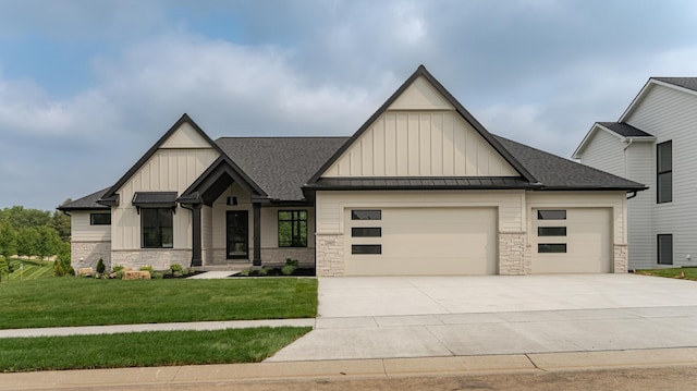 2665 Timber Oaks Rd SW, Rochester, MN 55902 - view of front of house with board and batten siding, an attached garage, a shingled roof, concrete driveway, and stone siding