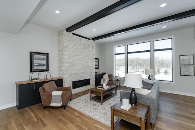 2665 Timber Oaks Rd SW, Rochester, MN 55902 - living area with wood finished floors, beam ceiling, a fireplace, and recessed lighting