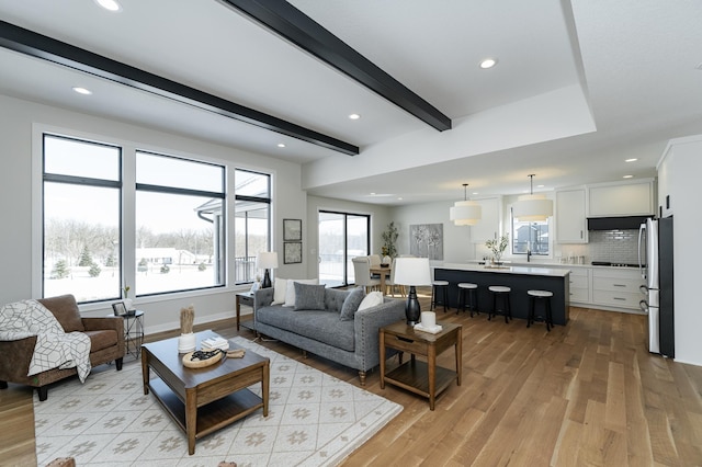 2665 Timber Oaks Rd SW, Rochester, MN 55902 - living room featuring light wood-style floors, beamed ceiling, and recessed lighting
