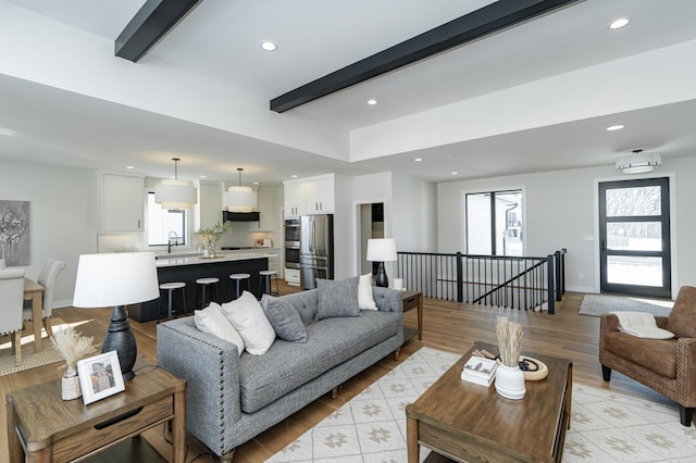 2665 Timber Oaks Rd SW, Rochester, MN 55902 - living area featuring beamed ceiling, recessed lighting, and light wood-style floors