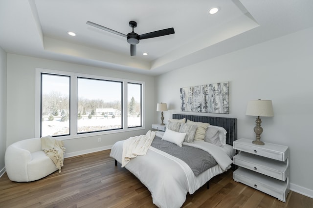 2665 Timber Oaks Rd SW, Rochester, MN 55902 - bedroom with a raised ceiling, wood finished floors, recessed lighting, and a ceiling fan