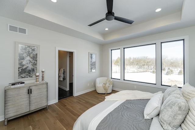 2665 Timber Oaks Rd SW, Rochester, MN 55902 - bedroom featuring a tray ceiling, wood finished floors, recessed lighting, and ceiling fan