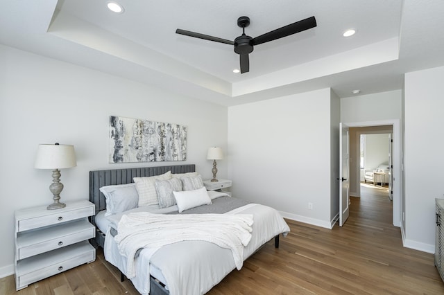 2665 Timber Oaks Rd SW, Rochester, MN 55902 - bedroom featuring a tray ceiling, wood finished floors, recessed lighting, and a ceiling fan