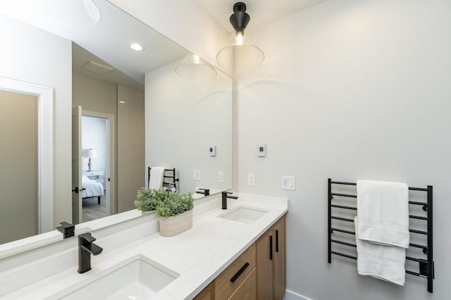 2665 Timber Oaks Rd SW, Rochester, MN 55902 - bathroom featuring a towel warming rack, double vanity, and connected bathroom