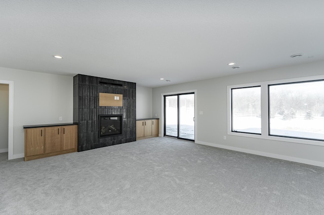2665 Timber Oaks Rd SW, Rochester, MN 55902 - unfurnished living room featuring a large fireplace, light carpet, and recessed lighting