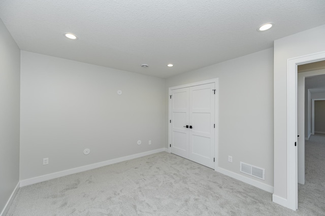2665 Timber Oaks Rd SW, Rochester, MN 55902 - unfurnished bedroom featuring carpet floors, recessed lighting, a textured ceiling, and a closet