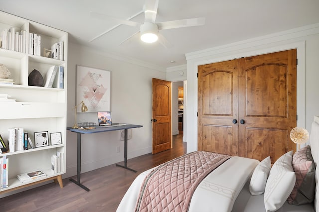 bedroom featuring dark wood-type flooring, ceiling fan, and ornamental molding