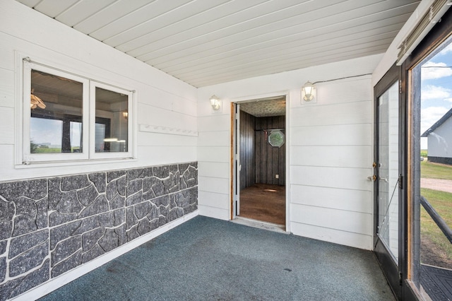 unfurnished sunroom featuring wooden ceiling