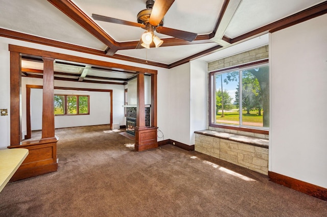 unfurnished living room with baseboards, ceiling fan, beamed ceiling, carpet flooring, and ornate columns