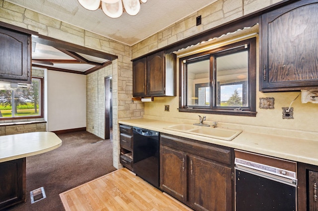 kitchen featuring dark brown cabinetry, black dishwasher, light countertops, and a sink