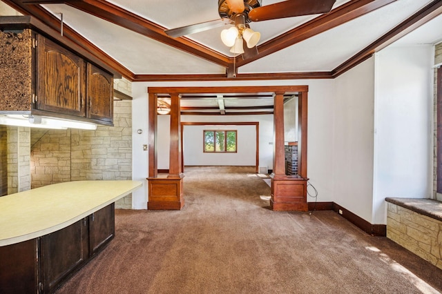 interior space featuring baseboards, light countertops, crown molding, carpet floors, and ornate columns