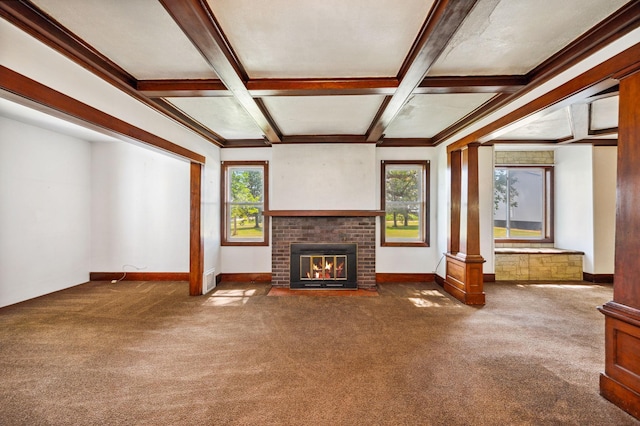 unfurnished living room featuring coffered ceiling, a brick fireplace, beamed ceiling, carpet, and decorative columns