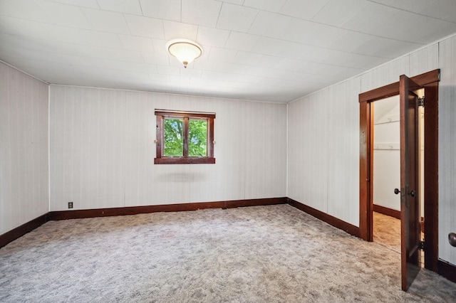 carpeted empty room with baseboards