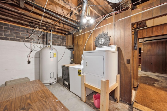 unfinished basement with electric water heater and washer and dryer