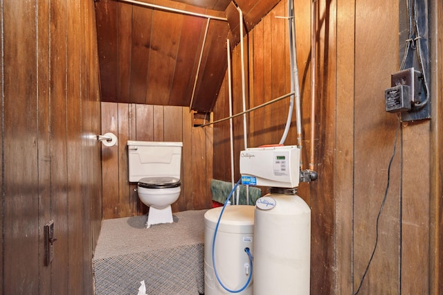 bathroom with wooden walls and toilet