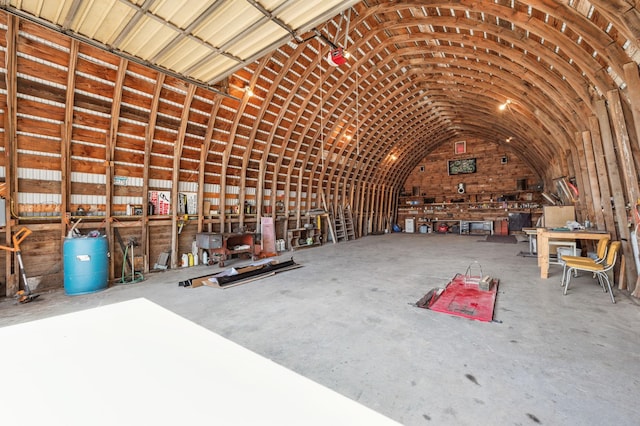 misc room featuring concrete floors and vaulted ceiling