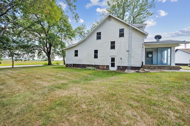 view of side of property with a yard