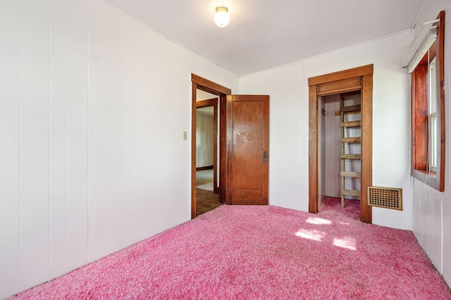 unfurnished bedroom with carpet and visible vents