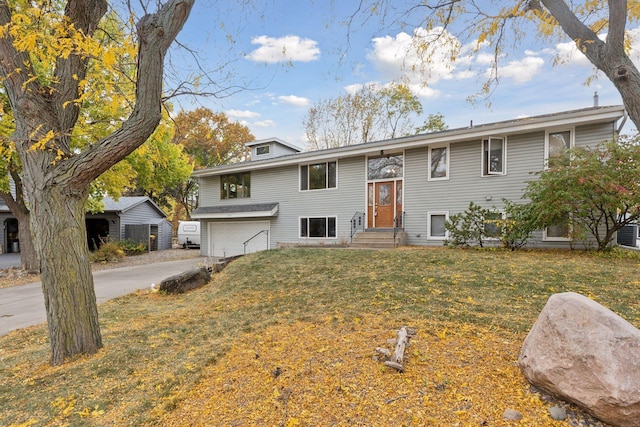 split foyer home with a front lawn and a garage