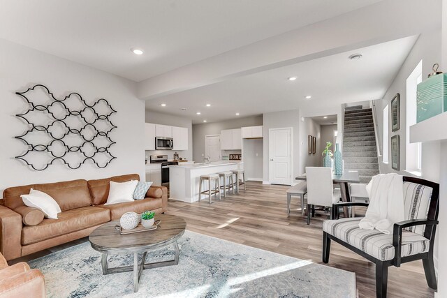 living room with sink and light hardwood / wood-style floors