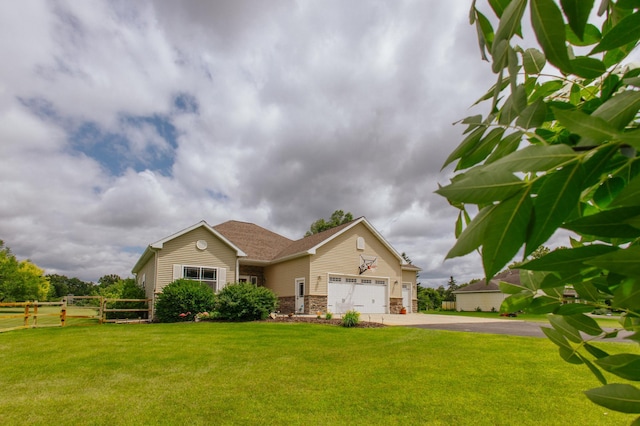 view of front of home with a front yard and a garage