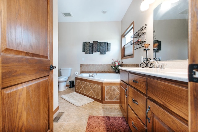 bathroom featuring tile patterned flooring, vanity, toilet, and a relaxing tiled tub