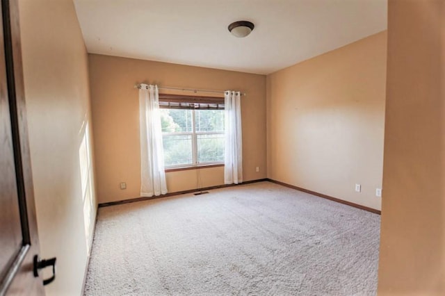 empty room with light colored carpet