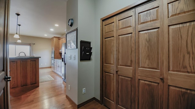 hall featuring hardwood / wood-style flooring and sink